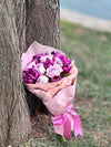 Bouquet of Purple Tulips and Pink Roses in Elegant Packaging
